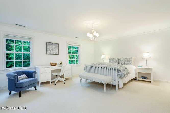 16 Normandy Lane Riverside, CT 06878 - Photo 29 of 43 a spacious bedroom with a bed and a couch