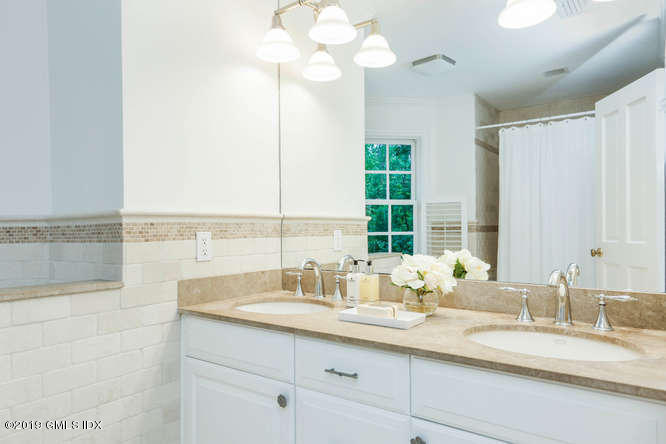 16 Normandy Lane Riverside, CT 06878 - Photo 32 of 43 a bathroom with a double vanity sink and a mirror