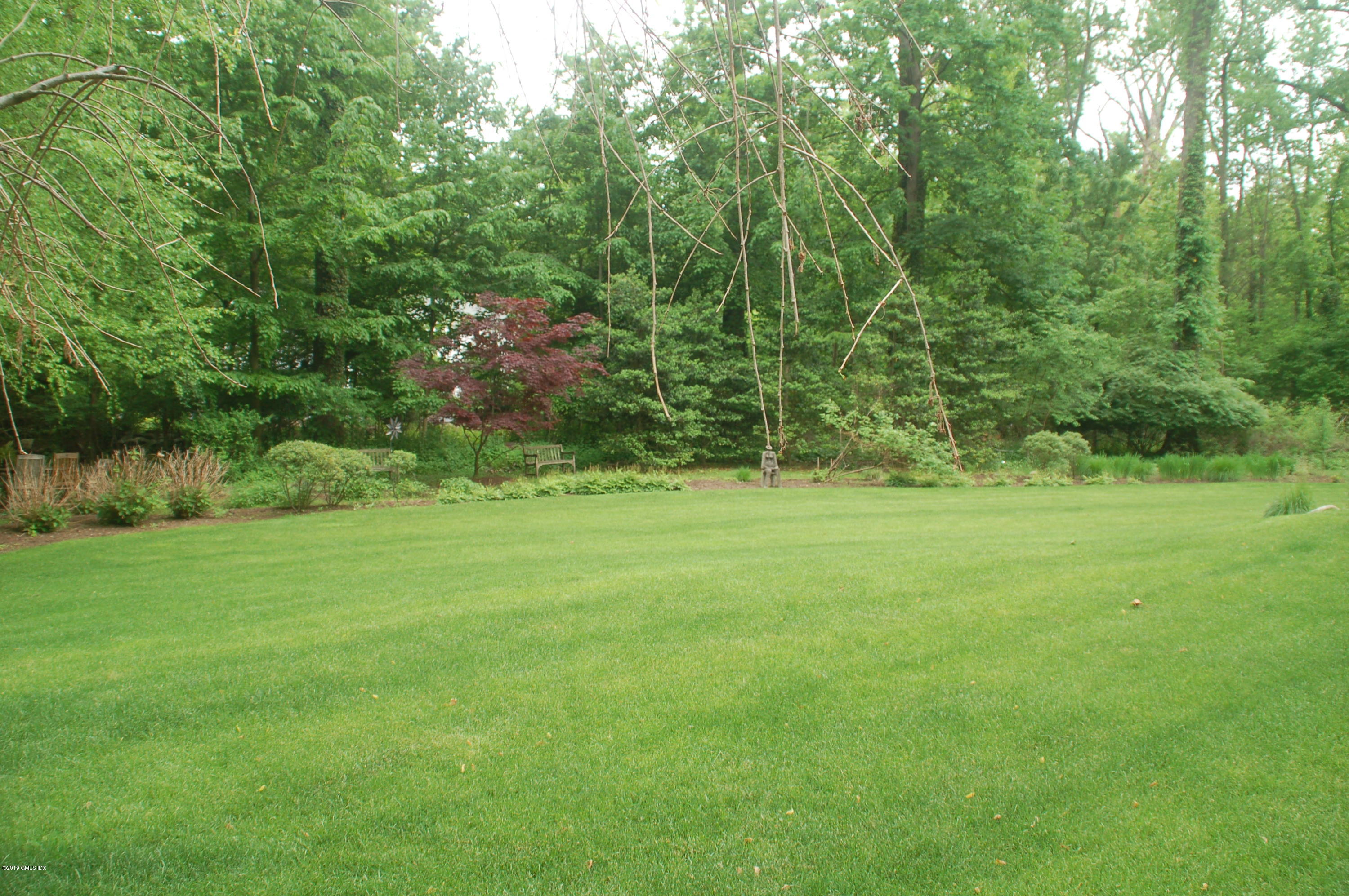 16 Normandy Lane Riverside, CT 06878 - Photo 7 of 43 a view of a grassy field with trees