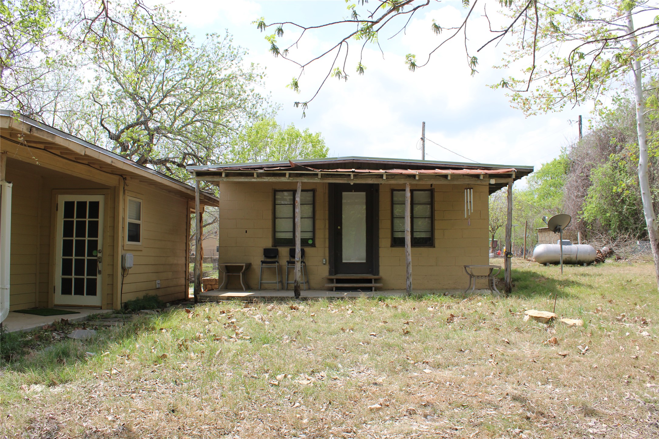 908 River Road Wimberley, TX 78676 - Photo 14 of 16 Rear view of property featuring a patio and concrete block siding