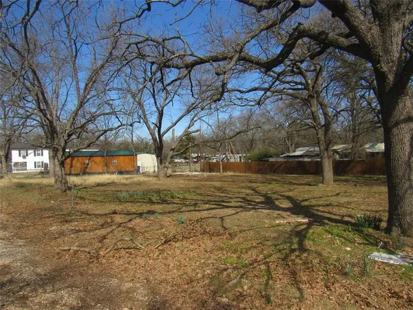 a view of yard covered with snow in front of house