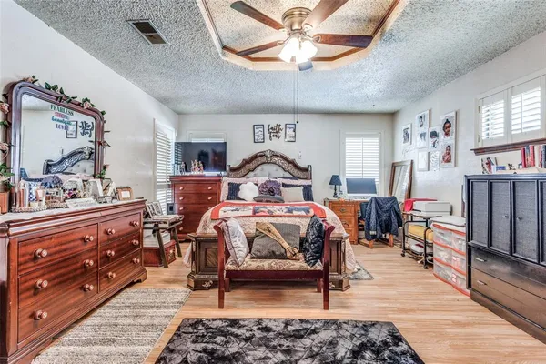 a bedroom with furniture and a mirror