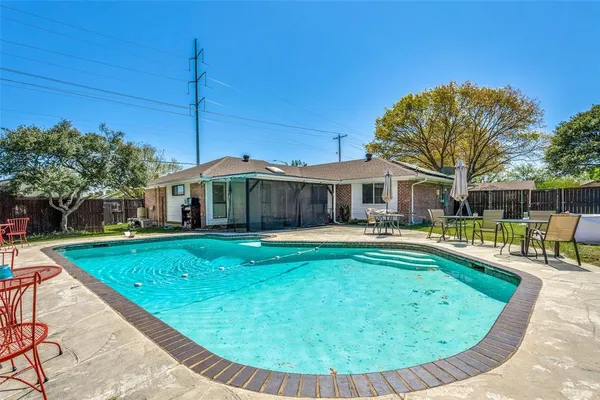 a view of a house with swimming pool and sitting area