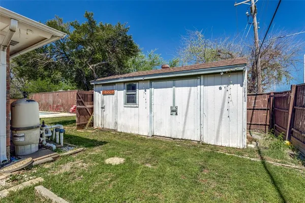 a view of backyard with table and chairs and potted plants