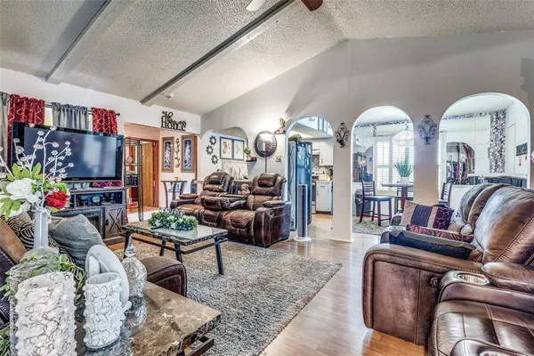 a living room with furniture fireplace and a chandelier
