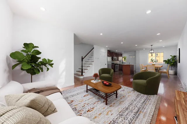 a living room with furniture and a potted plant