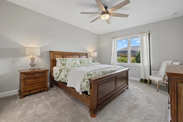 a bed sitting in a bedroom next to a window