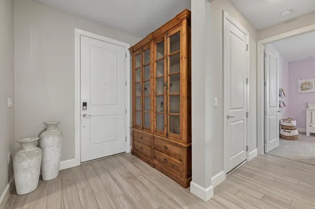 a view of room with wooden floor and bathroom