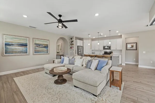 a living room with kitchen island furniture and a wooden floor