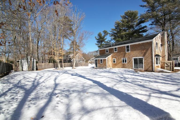 21 Mayflower Road Mashpee, MA 02649 - Photo 18 of 22 a front view of a house with a yard