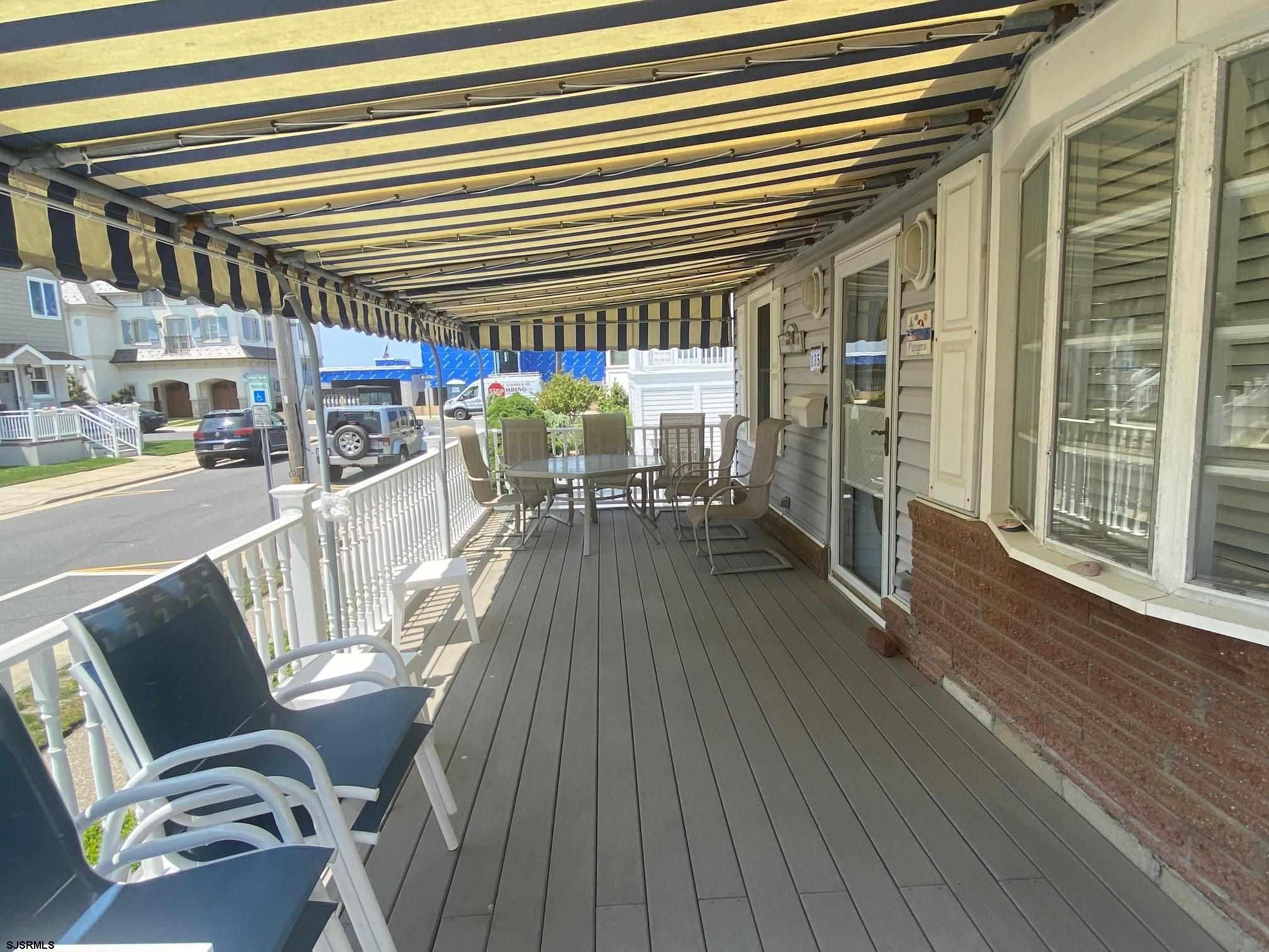 135 North Woodcrest Avenue, Unit MD WEEKEND TO JUNE 30 Longport, NJ 08403 - Photo 12 of 14 a view of a patio with table and chairs and wooden floor