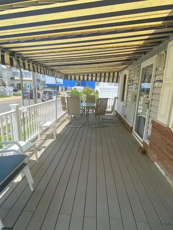 a view of a roof deck with a table and chairs
