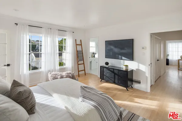 a bedroom with a bed and a flat screen tv