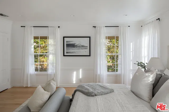 a bedroom with furniture and a window