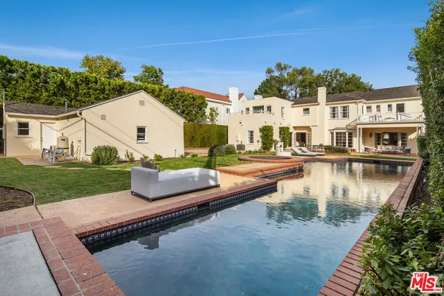 a swimming pool view with a outdoor seating