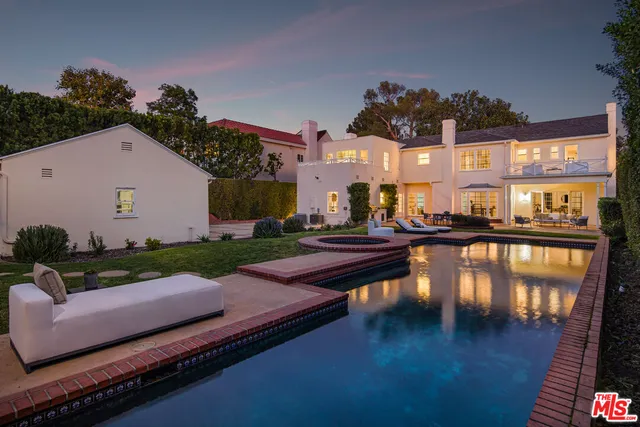 a swimming pool with outdoor seating and garden