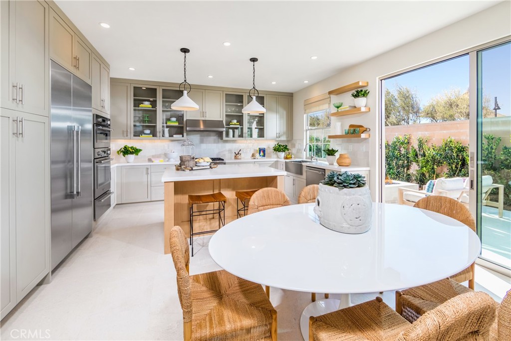 115 Anthem Irvine, CA 92618 - Photo 2 of 4 a kitchen with a table chairs and refrigerator
