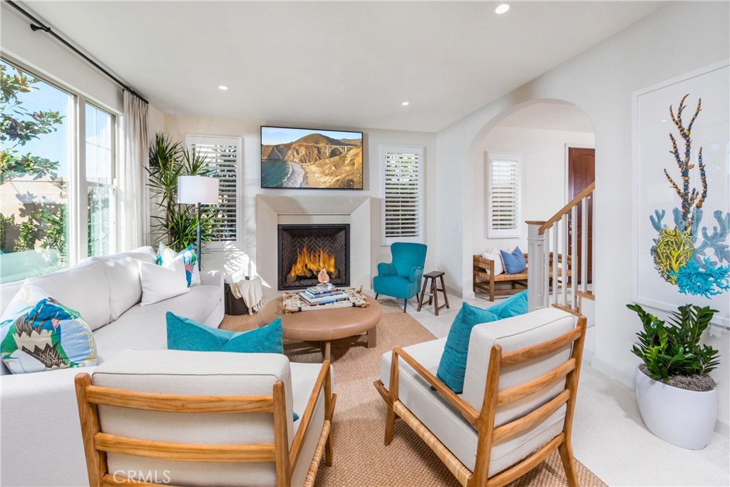115 Anthem Irvine, CA 92618 - Photo 3 of 4 a living room with furniture a fireplace and a potted plant