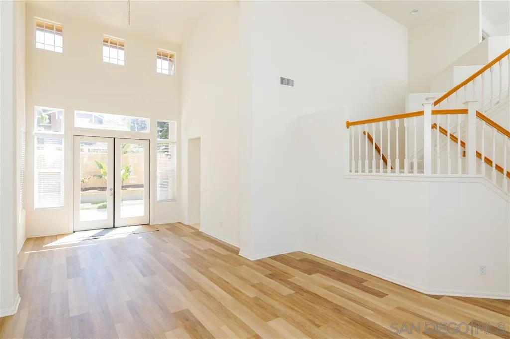 1935 Ivy Road Oceanside, CA 92054 - Photo 8 of 25 a view of an empty room with wooden floor and a window