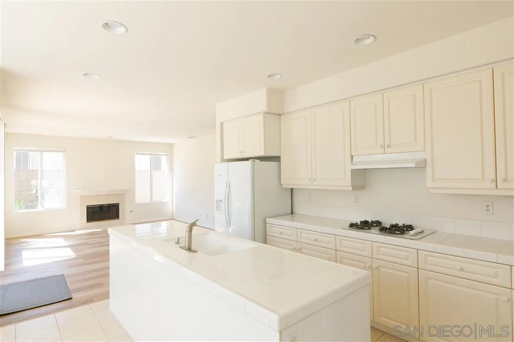 1935 Ivy Road Oceanside, CA 92054 - Photo 10 of 25 a kitchen with granite countertop white cabinets and white appliances