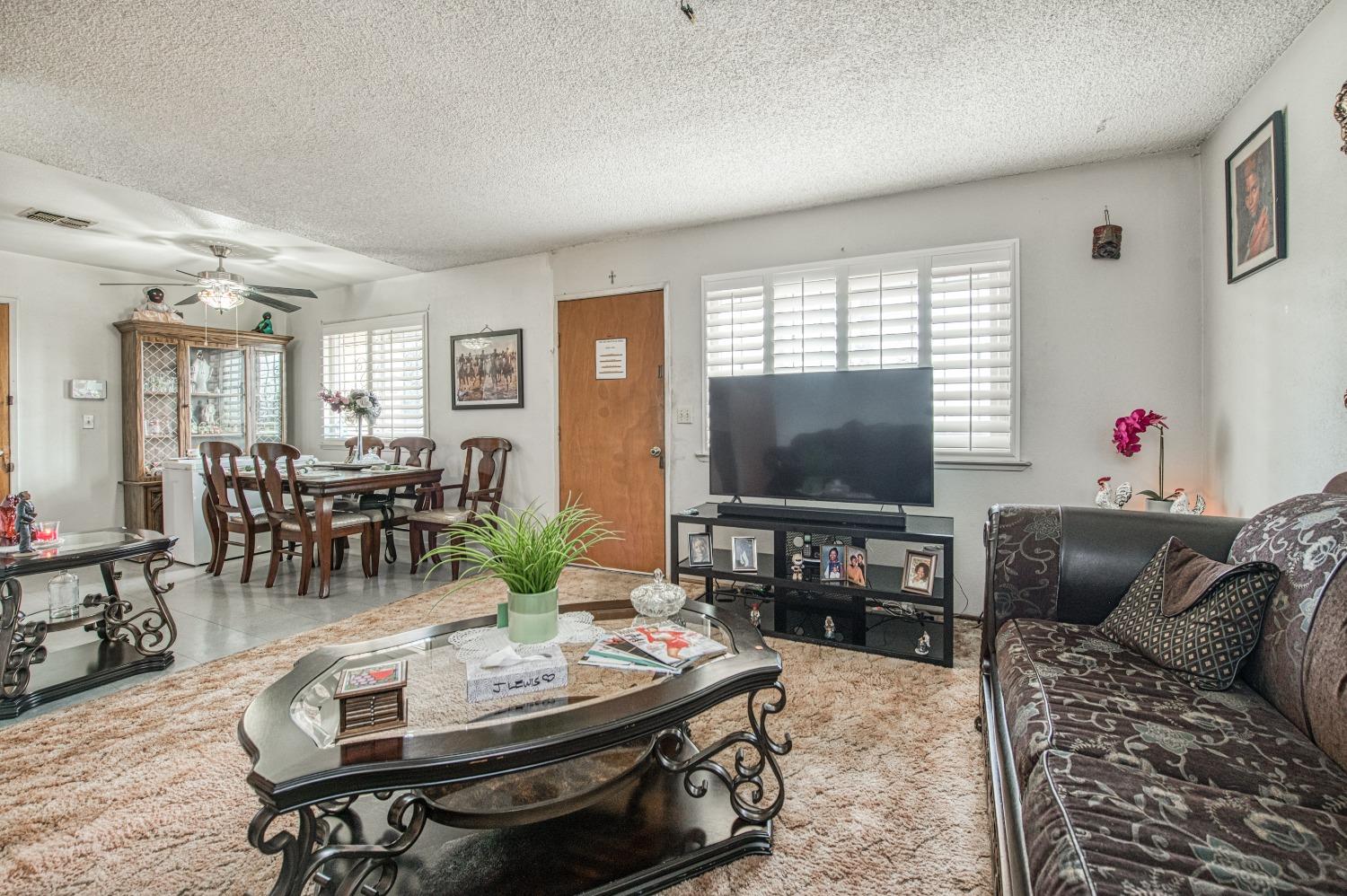 717 Clinton Street Madera, CA 93638 - Photo 11 of 38 a living room with furniture and a flat screen tv