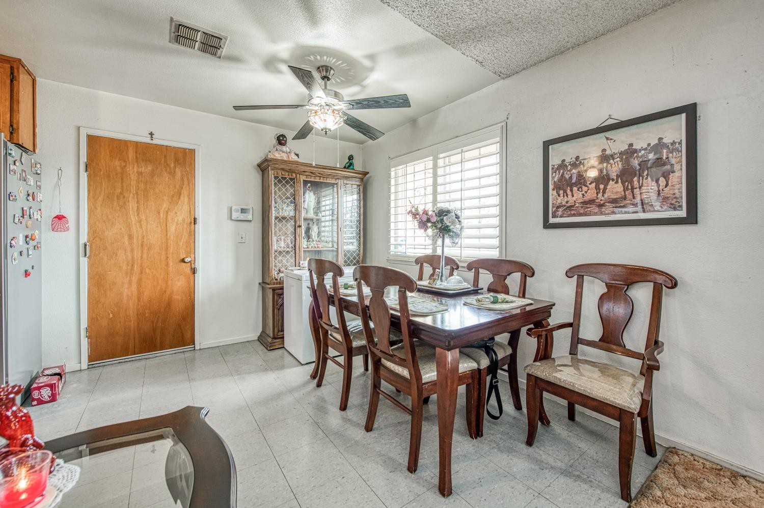 717 Clinton Street Madera, CA 93638 - Photo 12 of 38 a view of a dining room with furniture and chandelier