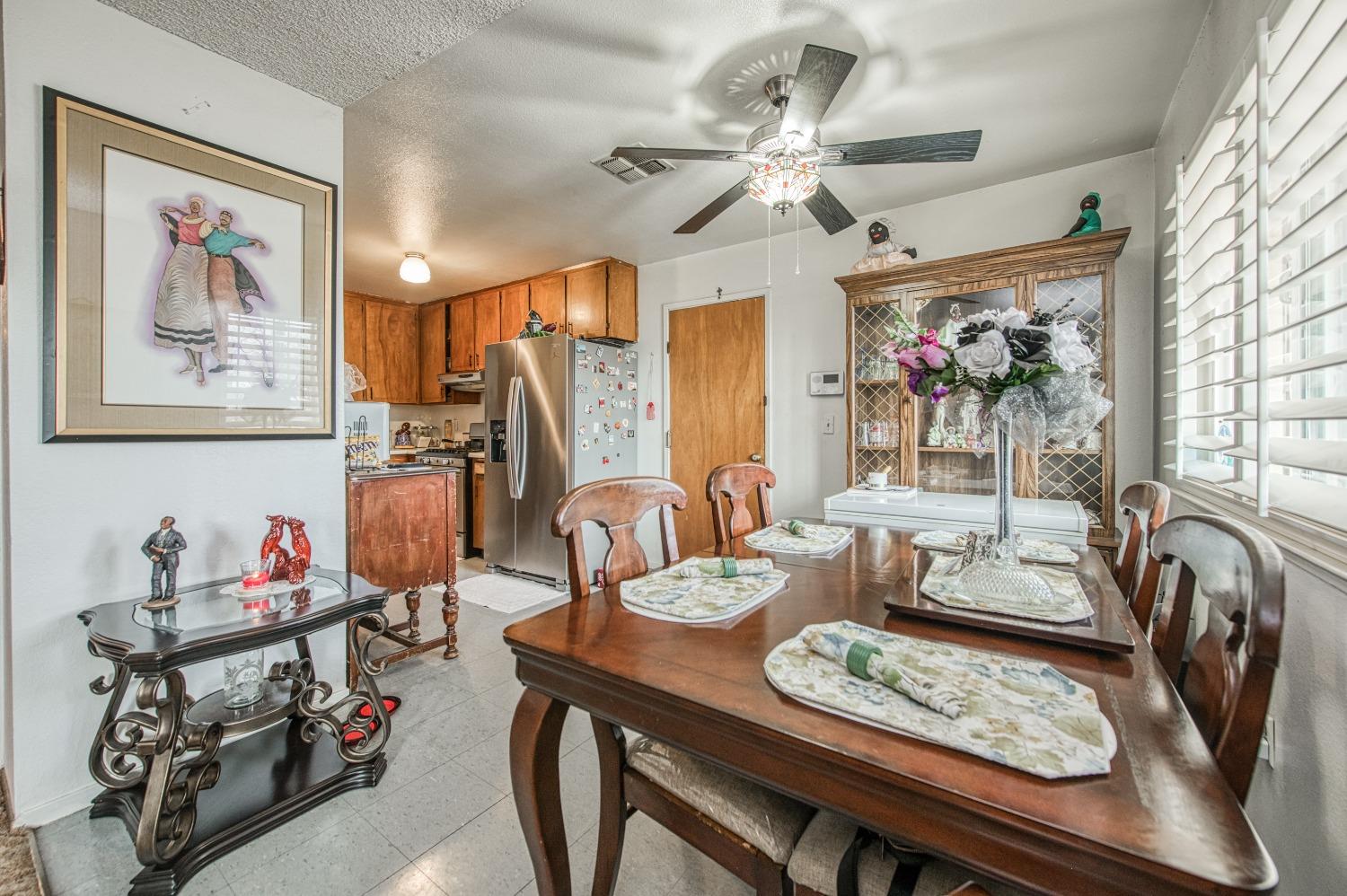 717 Clinton Street Madera, CA 93638 - Photo 13 of 38 a view of a dining room with furniture and a chandelier
