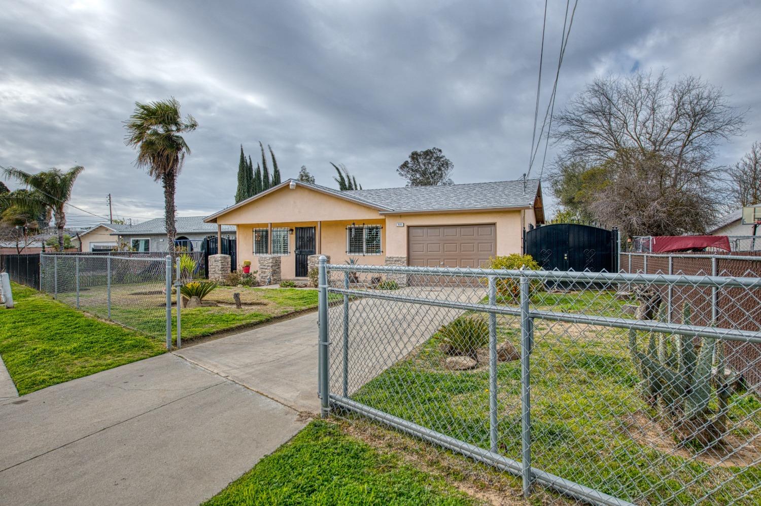 717 Clinton Street Madera, CA 93638 - Photo 2 of 38 a view of a house with swimming pool and a yard