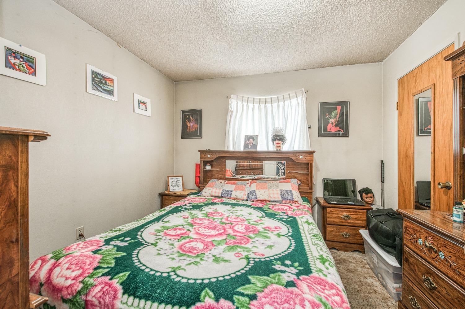 717 Clinton Street Madera, CA 93638 - Photo 26 of 38 a bedroom with a bed and a table