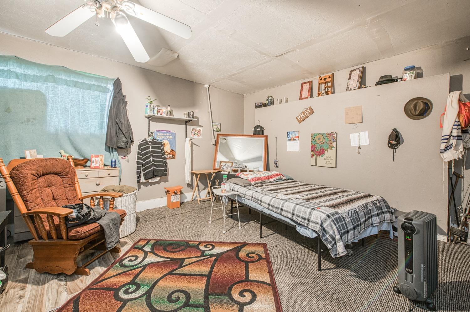 717 Clinton Street Madera, CA 93638 - Photo 30 of 38 a bedroom with furniture and a chandelier