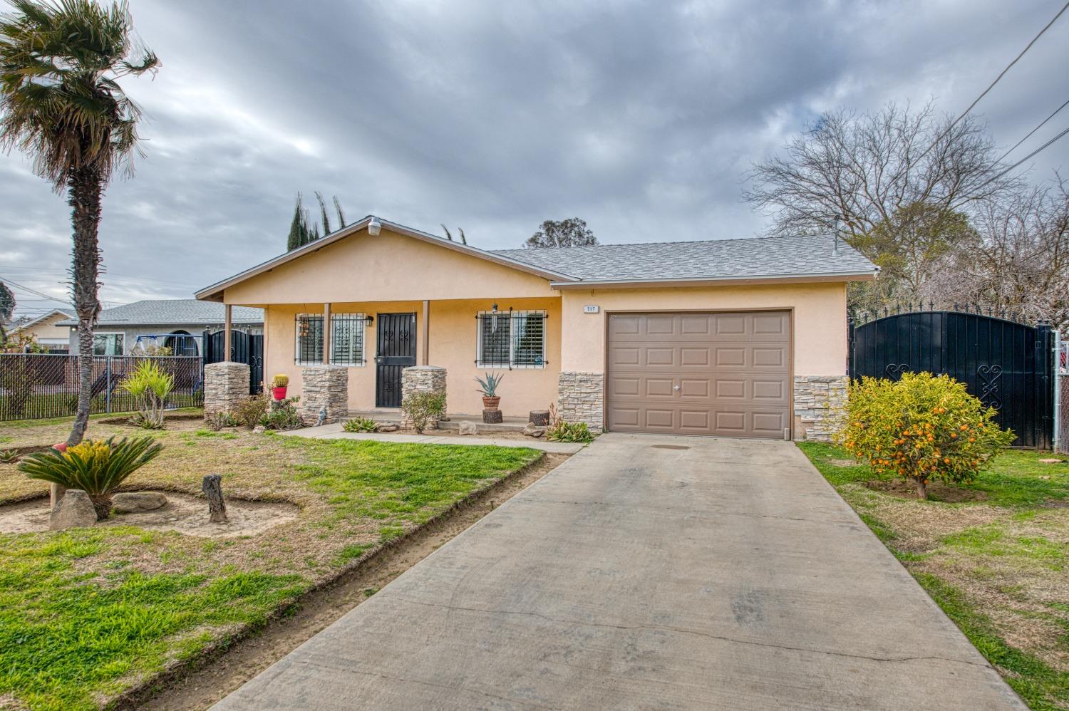 717 Clinton Street Madera, CA 93638 - Photo 3 of 38 a front view of a house with garden