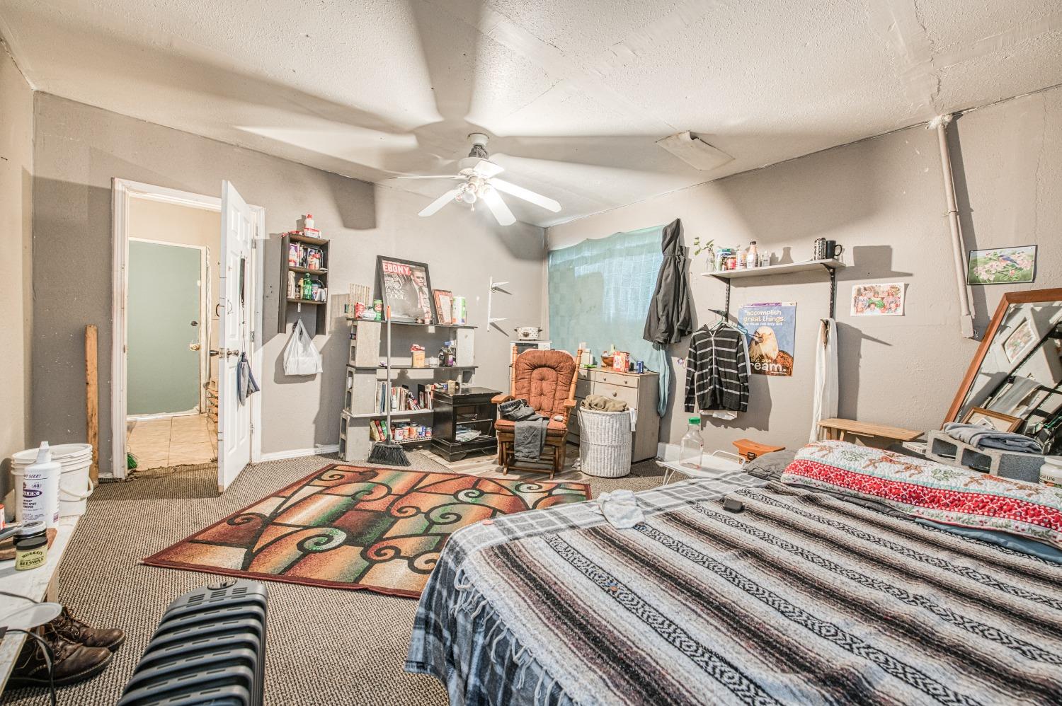 717 Clinton Street Madera, CA 93638 - Photo 31 of 38 a bedroom with furniture and a chandelier