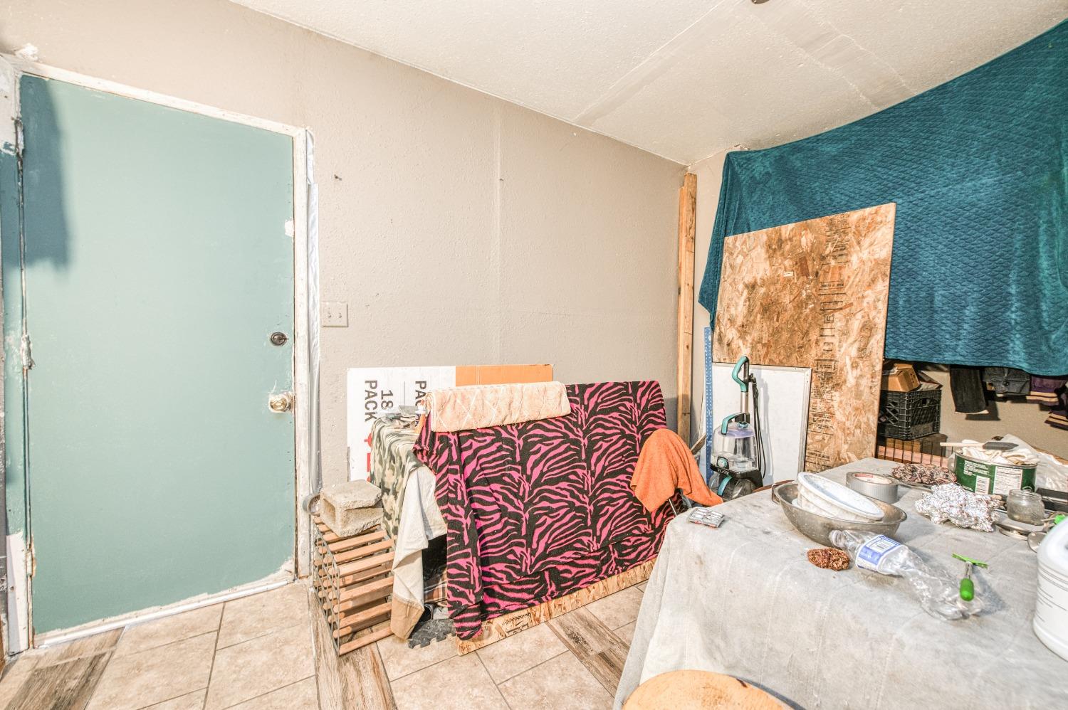 717 Clinton Street Madera, CA 93638 - Photo 32 of 38 a bedroom with a bed and a couch