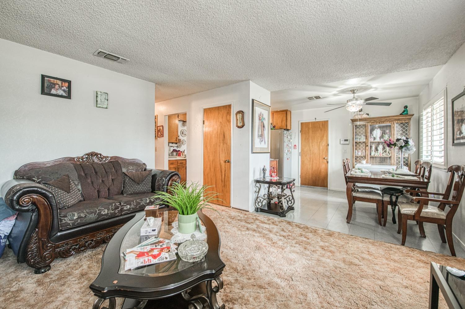 717 Clinton Street Madera, CA 93638 - Photo 10 of 38 a living room with furniture and a couch