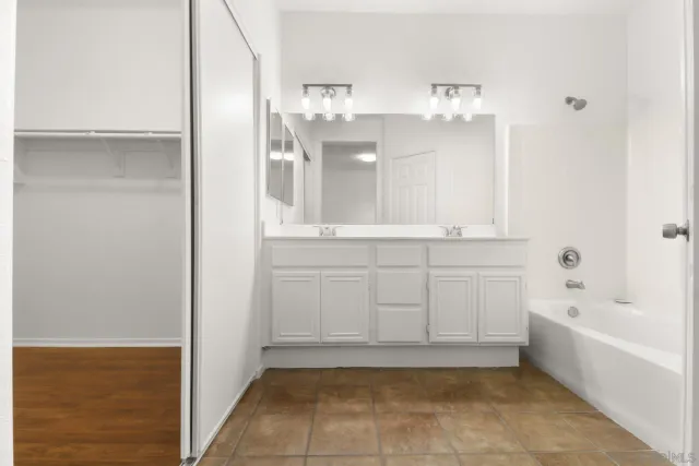 a bathroom with a bathtub and shower