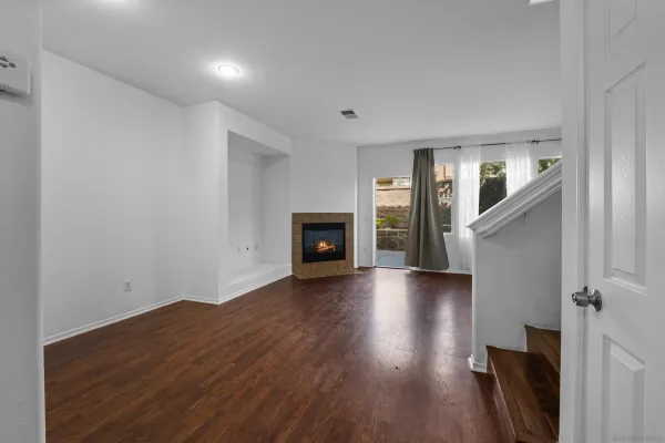 wooden floor in an empty room with a fireplace