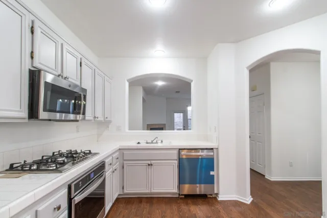 a kitchen with a sink stove and microwave