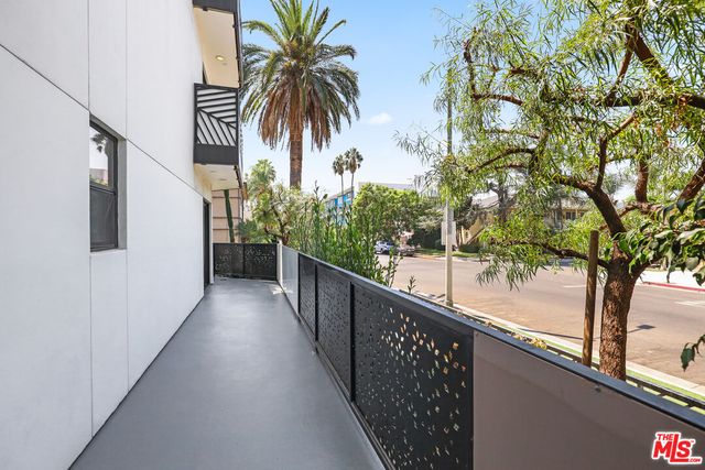 a view of a kitchen with stainless steel appliances refrigerator and microwave