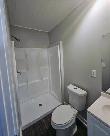 a white toilet sitting next to a bathroom sink