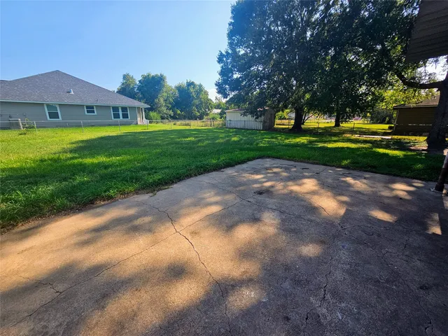a view of a street with a house in the background