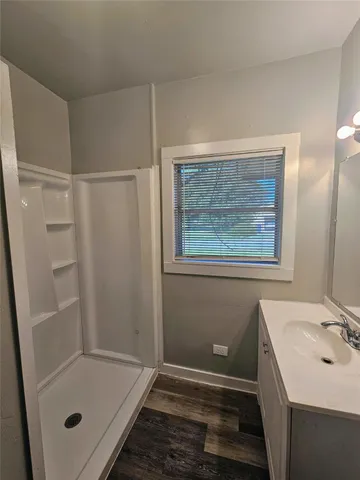 a bathroom with a sink and shower