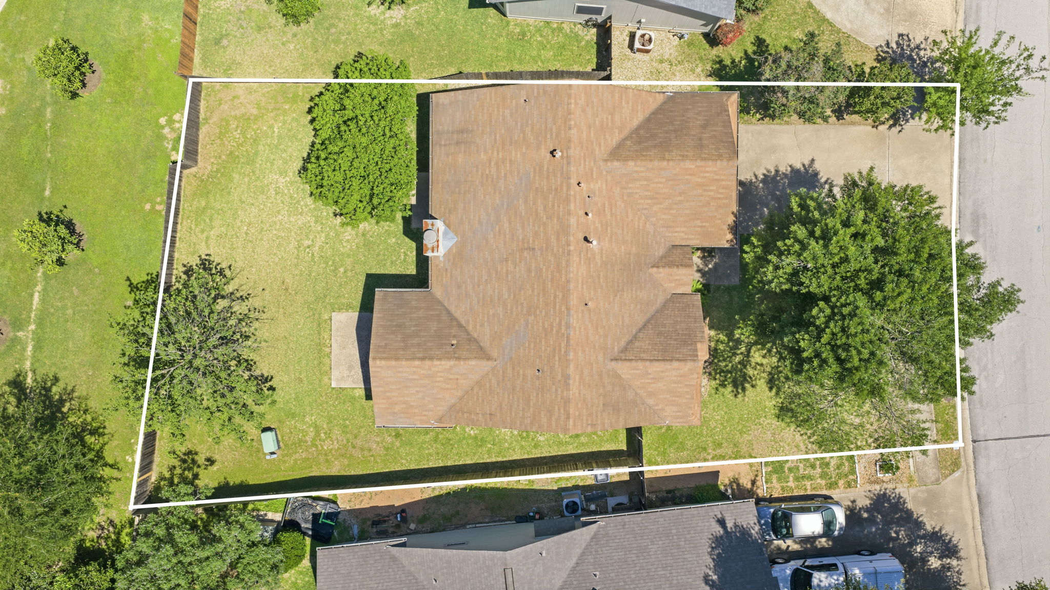 14818 Yellowleaf Trail Austin, TX 78728 - Photo 21 of 26 Aerial view highlighting the property's roofline, surrounding green space, and concrete driveway