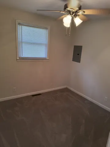 a view of an empty room with a fan