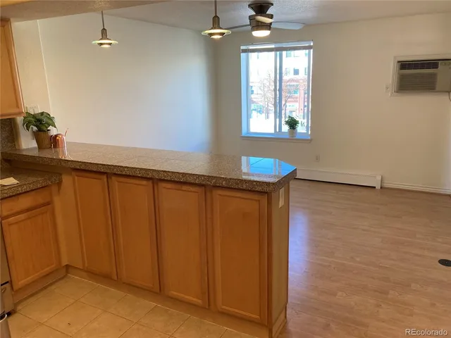 a view of a room with wooden floor and cabinet