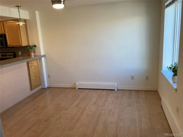 an empty room with windows and closet