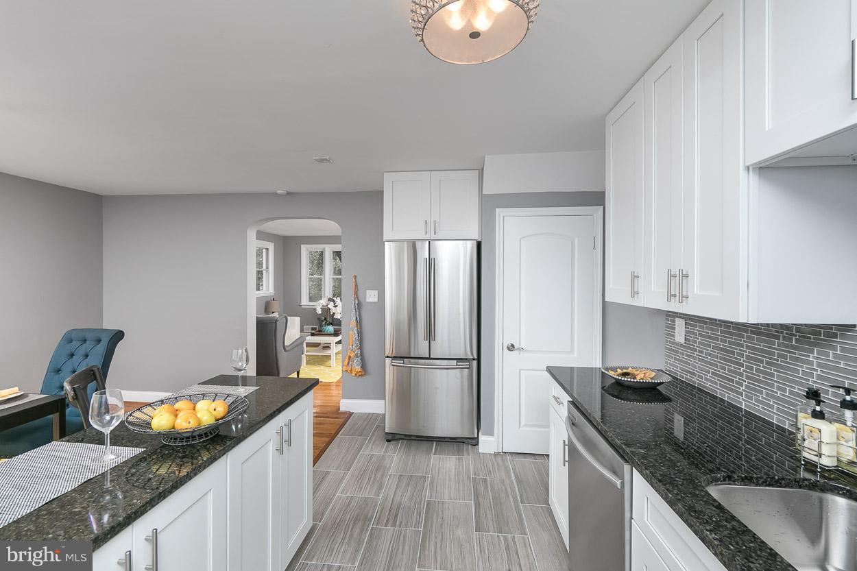 901 Stamford Road Baltimore, MD 21229 - Photo 14 of 27 a kitchen with granite countertop a refrigerator stove and sink