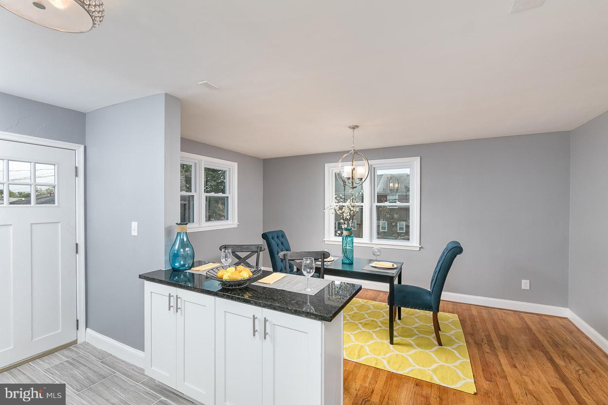 901 Stamford Road Baltimore, MD 21229 - Photo 15 of 27 a kitchen with a table chairs and wooden floor