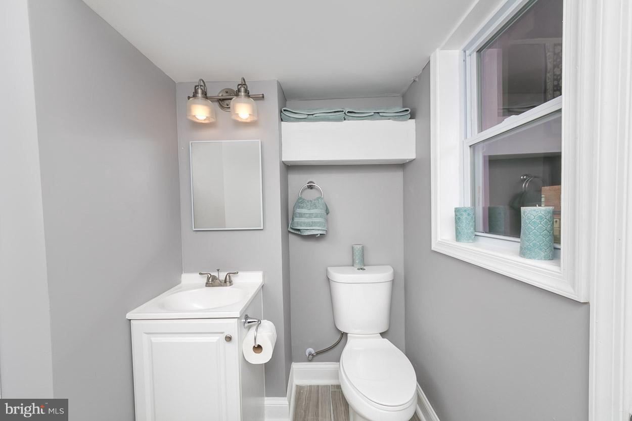 901 Stamford Road Baltimore, MD 21229 - Photo 27 of 27 a white toilet sitting next to a bathroom sink