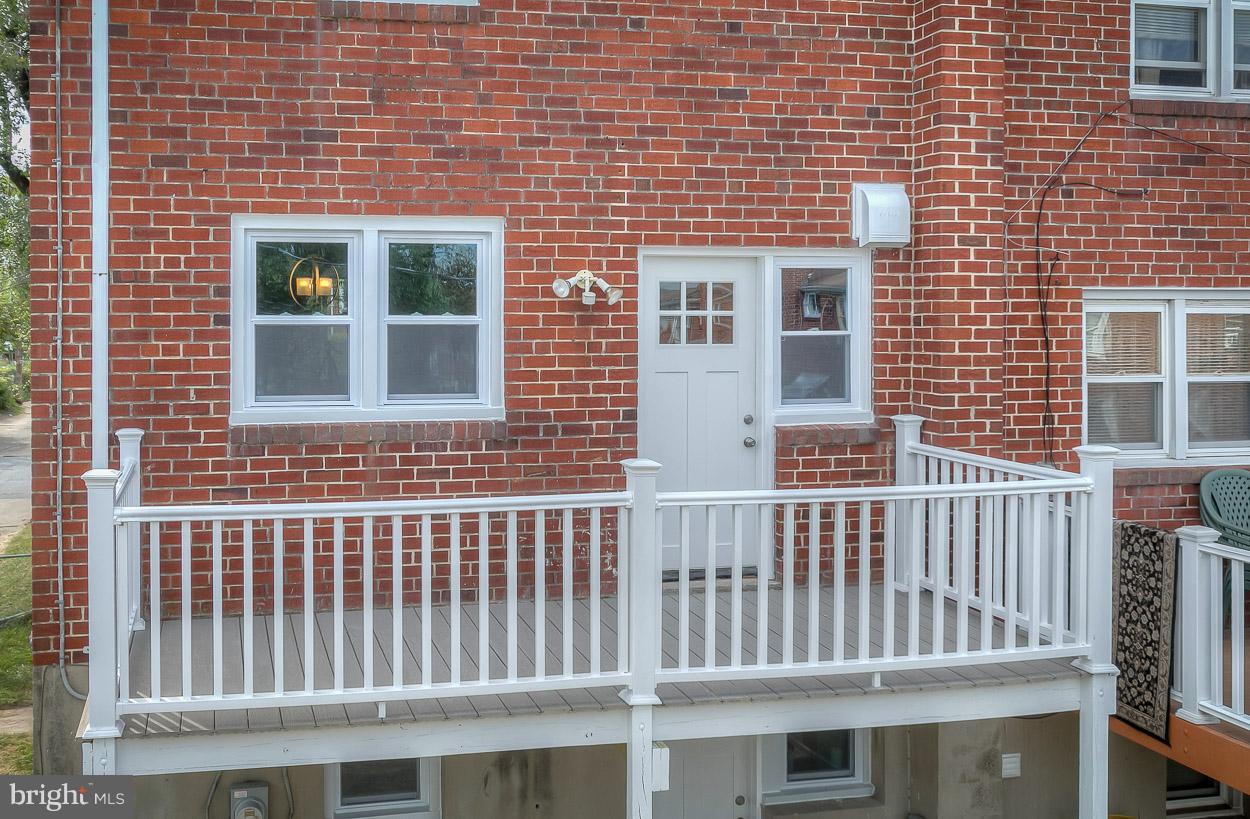 901 Stamford Road Baltimore, MD 21229 - Photo 4 of 27 a front view of a brick house with many windows