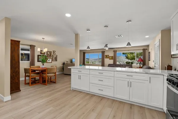 a kitchen with sink cabinets and wooden floor
